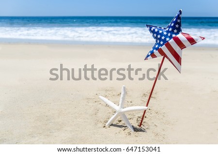 Patriotic USA background with starfish and decorations on the sandy beach