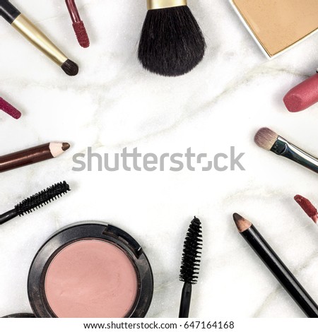 Makeup brushes, pencils, lipstick and other objects, forming a frame on a light background, with copy space. A square template for a makeup artist's business card or flyer design