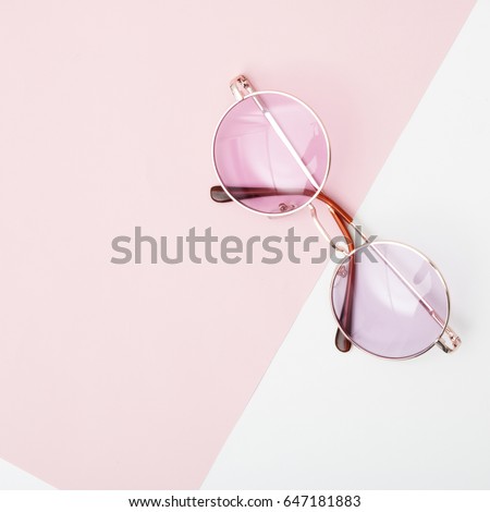 Minimal style. Minimalist fashion photography. Vintage. Glamour. Pink sunglasses on pastel backgrounds. Flat lay
