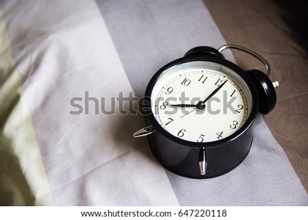 Alarm clock on the bed