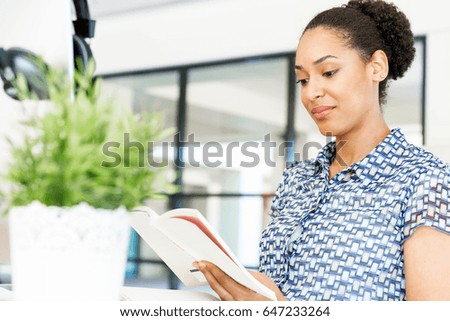Portrait of smiling afro-american office worker sitting in offfice