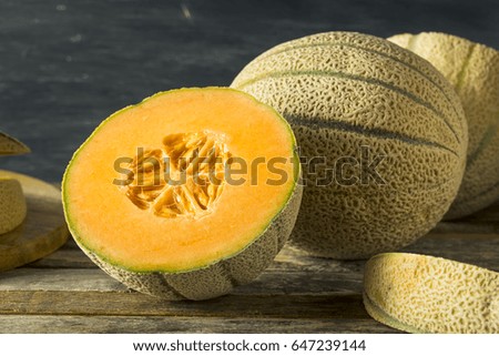 Raw Organic Tuscan Melon Cantaloupe Cut into Pieces Royalty-Free Stock Photo #647239144