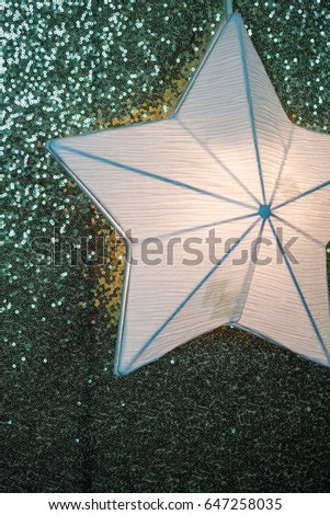 Paper star bulb light with sparkles christmas background