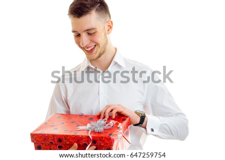 Happy guy opens the gift in red box