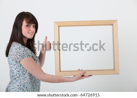 Young woman with a wooden frame