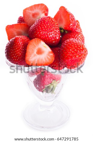 Few strawberries in glass cup isolated on white