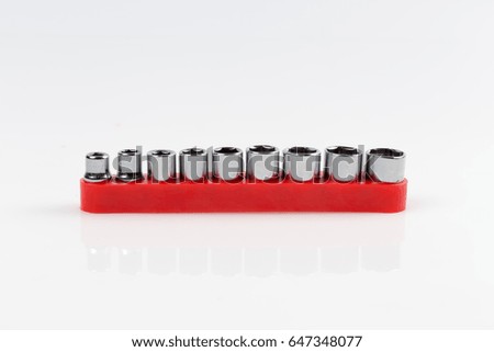 Ratchet and a set of interchangeable heads for chrome socket wrench. on white background.