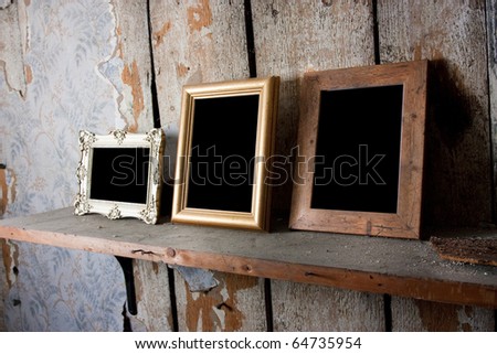 selection of empty blank picture frames in an old attic room