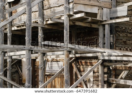 Old wooden scaffolding. Spatial structure. Dirty damaged weathered texture.