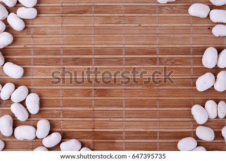 White beans on  bamboo mat. Background of  bamboo mat