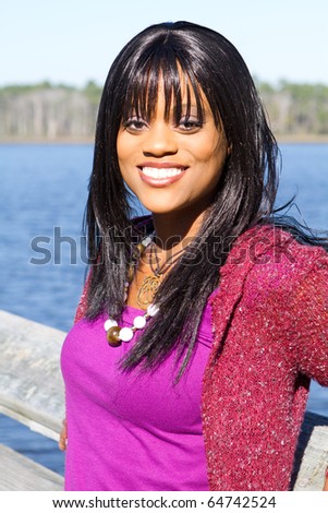 Successful young African American business woman at a lake setting. Royalty-Free Stock Photo #64742524
