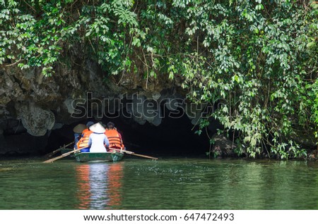 Boat with tourist travel into the cave trang an Vietnam world heritage with mountain and river.
