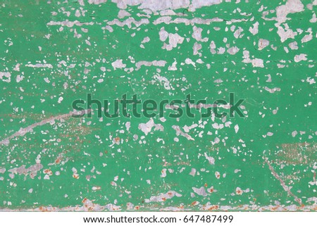 The flaking green color with scratched on the surface of rusty galvanized iron plate may be used as background 