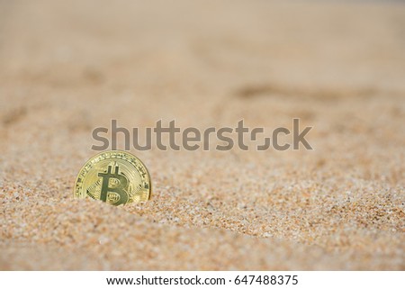 Golden Bitcoins on the beach.