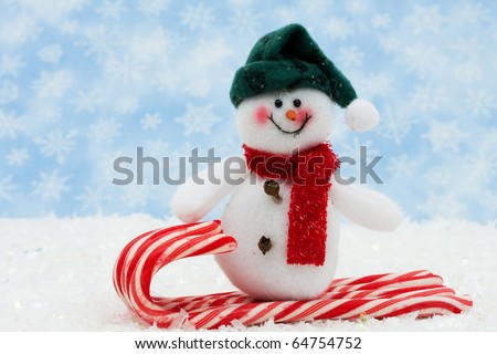 snowman on a candy cane sled with snow, Snowman having fun