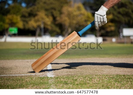 Cropped image of player scoring run on cricket field