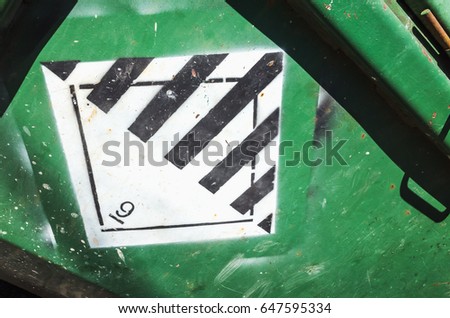 Warning sign on green cargo container. Hazard class 9. Miscellaneous dangerous substances