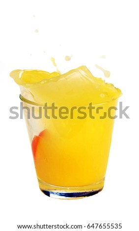 Splash in glass of juice with falling slice of orange isolated on white background