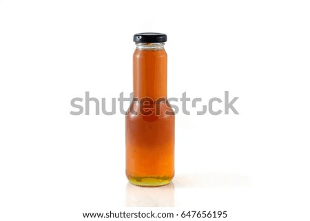 Coconut flower syrup in glass bottle and black closure. Isolated on white background.