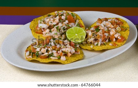 Healthy mexican meal, shrimp tostadas and vegetables on plate