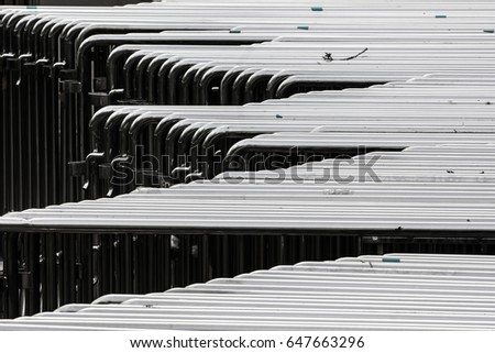 Abstract ?hrome plated tubes background. Chrome fence to separate the people.