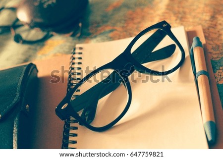 glasses and notebook map travel concept
