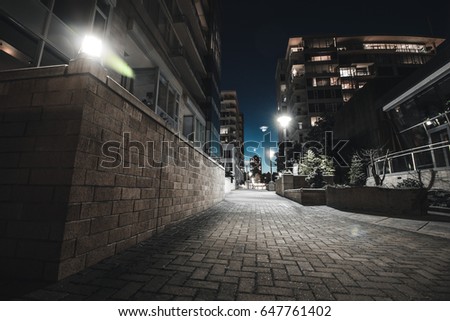 City buildings at night with lights