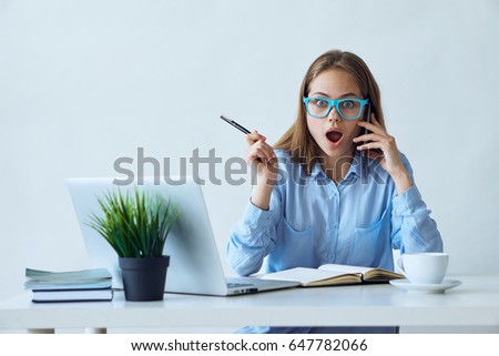 Woman with laptop talking on the phone                               