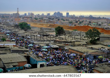 Slum in Angola, Africa. Capital city of Luanda. Poverty versus wealth in developing countries. Royalty-Free Stock Photo #647803567
