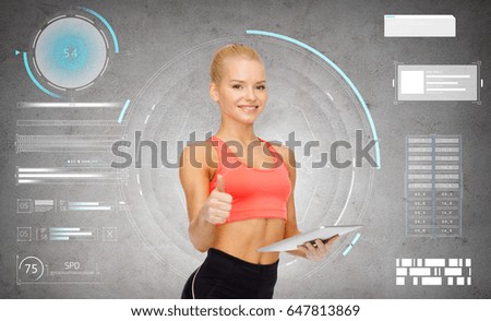 sport, fitness and technology - happy sporty woman with tablet pc computer showing thumbs up over gray concrete background