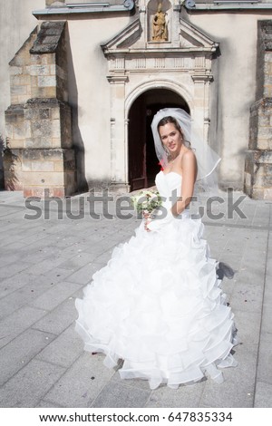 A nice and a beautiful bride in front of church celebration