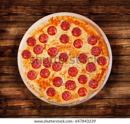 Pizza pepperoni on the  wooden table. This picture is perfect  to design your restaurant menus. Visit my page. You will be able to find an image for every pizza sold in your cafe or restaurant.