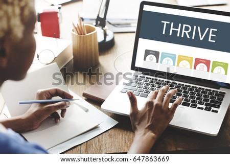 African woman working and using laptop on wooden table