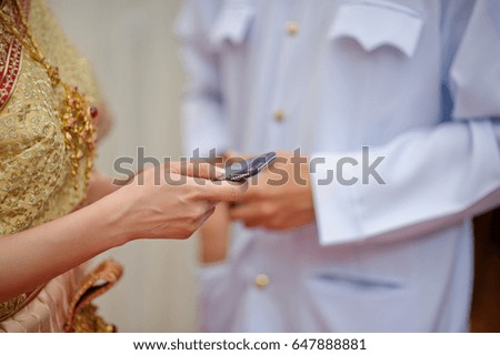 thai wedding with smartphone on hand