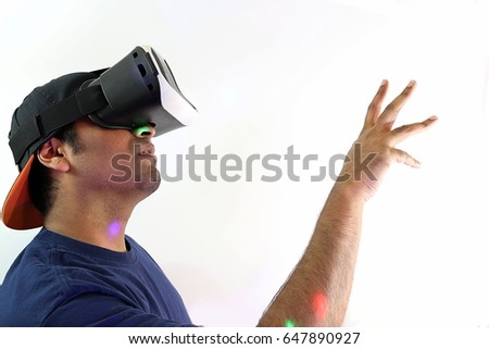Man reaching out while experiencing virtual reality  