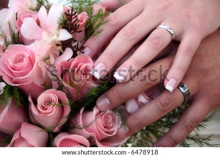 bride and grooms hands showing off their rings