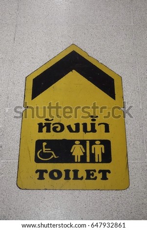 Toilet
Symbol to show the way to toilet on the floor of Thai building (Thai language in image is ‘toilet')