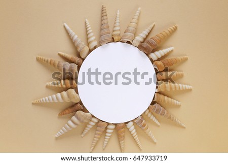 Round frame of  sea shells on a beige background. Marine layout. Holiday concept. Summer season
