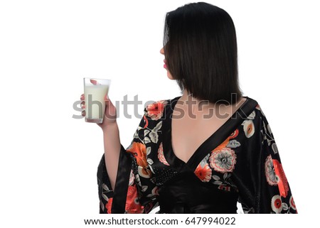 Happy young woman holding glass of milk. isolated