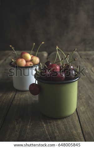 Freshly picked cherries on dark wooden table, close up