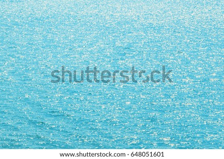 abstract image background of surface of blue sea or ocean water with glitter light from sunlight at day time.