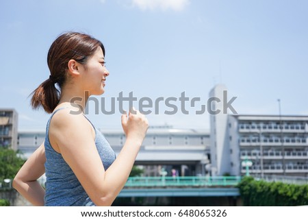 Young woman running with smile