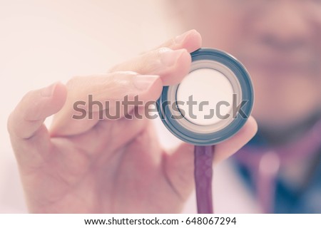Soft focus, Hand holding stethoscope.