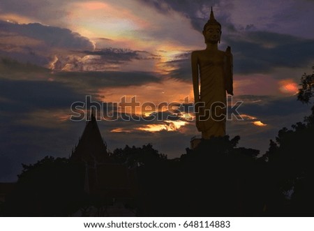 Big Buddha Location near the tree There is light in the background Clouds and multicolored skies, dark tones