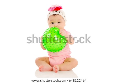 Asian baby sitting on the floor and playing toy