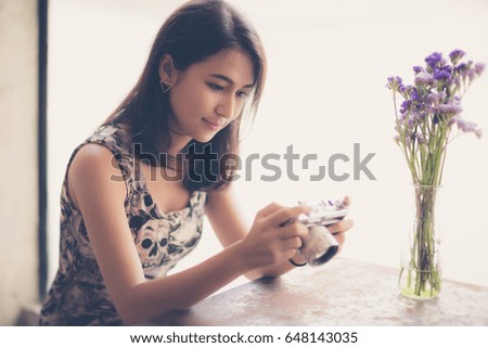 Asian woman holding Vintage camera on her holiday, Vintage color