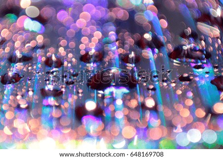 Multicolored water droplets close-up. Beautiful bokeh.