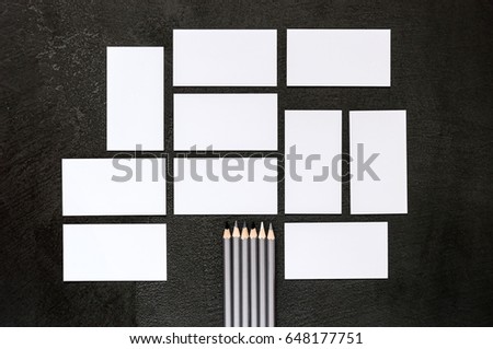 Business cards and stationery on a black background of stone table texture. Layout for branding. Sample for corporate identity. Template for graphic designers of presentations and portfolio.Top view