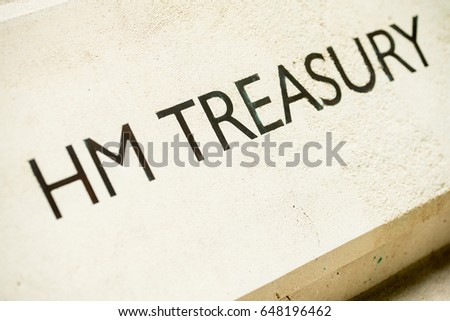 Angled view of HM TREASURY sign on Whitehall building in London, UK. Royalty-Free Stock Photo #648196462
