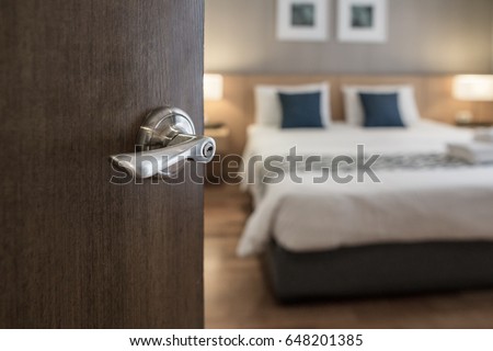 Hotel room , Condominium or apartment doorway with open door in front of blur bedroom background Royalty-Free Stock Photo #648201385